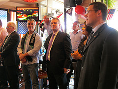 World Cup-winning former All Blacks Steve McDowell (l, with scarf) and Grant Fox, with US Consul in Auckland, Dana Deree
